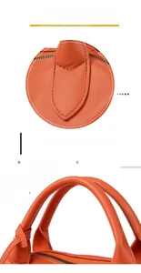 Dettaglio borsa arancione in pelle martellata con cuciture fitte e manico tondo rinforzato