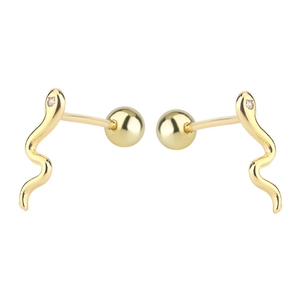 Macro shot of gold snake studs with zircon heads and secure screw ball backs