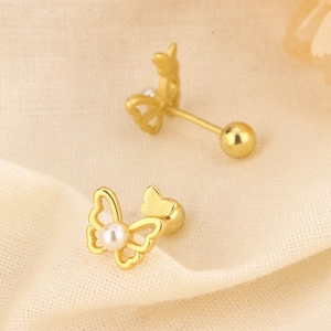 Detail of golden butterfly stud earrings with pearl accents and secure screw backs