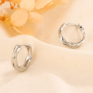 Macro detail of Mobius hoop earrings showing S925 sterling silver hallmark stamp