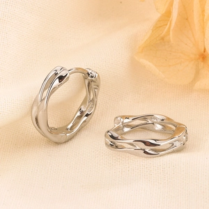 Elegant silver Mobius hoop earrings with a twisted liquid metal design and S925 stamp