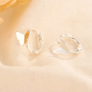 Close-up of butterfly hoop earrings in polished silver with S925 engraved stamp
