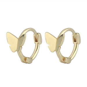 Close-up of polished golden butterfly hoop earrings with detailed wings on white background