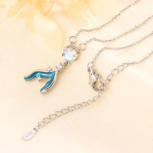 Macro view of S925 silver necklace featuring a blue fish tail pendant with moonstone