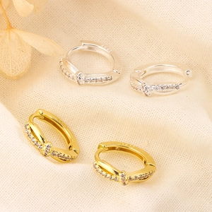 Detailed macro of S925 sterling silver knotted hoop earrings with sparkling cubic zirconia