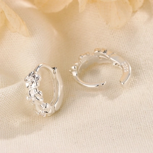 Macro view of S925 sterling silver flower earrings showing relief design and hallmark
