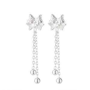 Detail of silver bow tassel earrings with double chains and polished metal beads