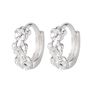 Macro detail of silver plated floral hoop earrings with sparkling zircon petal accents