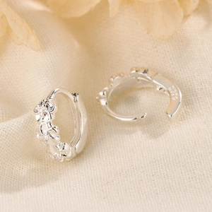 Elegant S925 silver flower hoop earrings with zircon accents on a textured beige fabric
