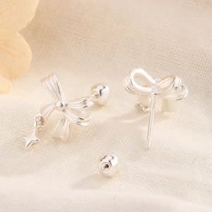 Minimalist silver bow earrings with star pendant and secure screw back closure