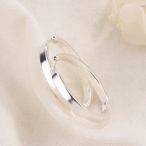 Close-up of polished S925 sterling silver hoop earrings with clear hallmark stamp