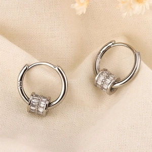 Macro detail of S925 sterling silver hoop earrings with square zircon transfer beads