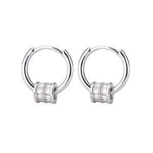 Close-up of silver hoop earrings with baguette-cut cubic zirconia luck beads