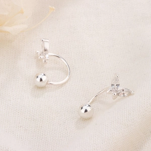 Macro detail of silver butterfly stud earring with marquise zircon inlay and screw ball back