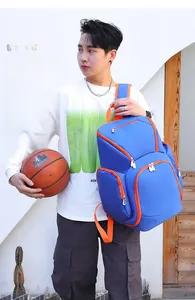 Close-up of blue water-resistant Oxford gym backpack with bright orange zippers and straps