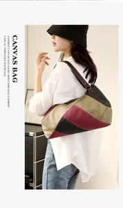 Close-up of color-block canvas tote bag with dark brown leather straps and metal hardware