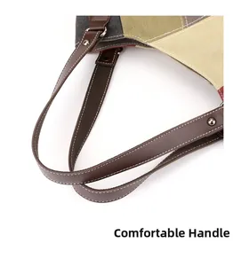 Detailed macro view of reinforced leather handles with white stitching on canvas tote