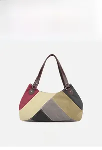 Front detail of large canvas tote bag with multi-color geometric patchwork design