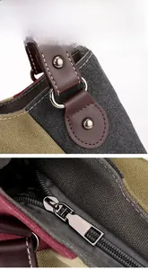Detail of color-block canvas tote bag showing leather strap joint and metal zipper closure