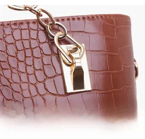 Vue détaillée du sac cabas marron gaufré crocodile avec poignée en métal doré renforcé