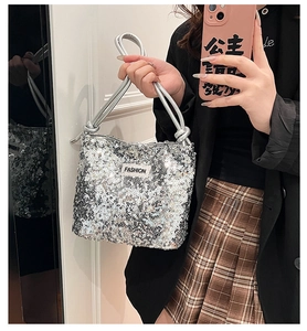 Détail d'un sac à bandoulière en paillettes argentées avec poignée à nœud élégante