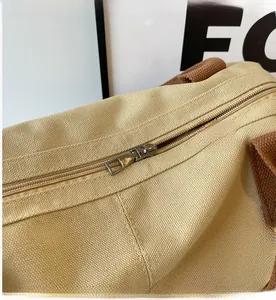 Detail of smooth metal zipper and thick khaki canvas texture on the tote bag