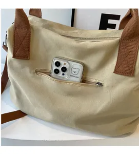 Close-up of minimalist canvas tote bag featuring a practical zipper pocket for smartphones
