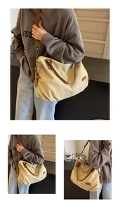 Detail of canvas tote bag with brown leather trim and adjustable drawstring sides
