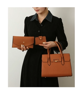 Detailed view of brown crocodile pattern tote bag with matching wallet and card holder set