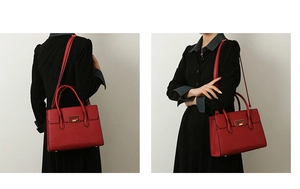 Detailed view of a red crocodile pattern tote bag with metal buckle and shoulder strap