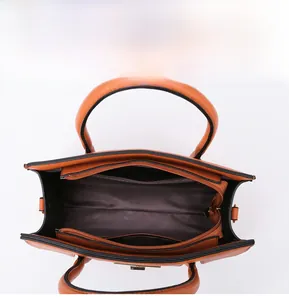 Top view of orange pebbled leather tote interior with zipper divider and fabric lining