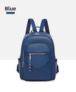 Detail of blue PU leather backpack featuring lychee texture and V-shaped stitching accents