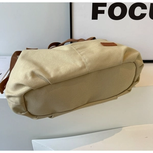 Detailed macro view of high-density beige canvas texture and durable brown strap