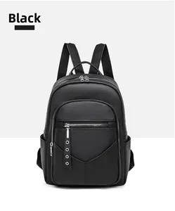 Detailed view of large capacity black PU leather backpack with lychee texture and silver zippers