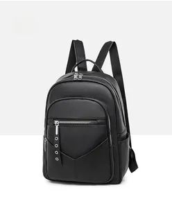 Side view of black PU leather backpack showing lychee texture and silver metal zippers