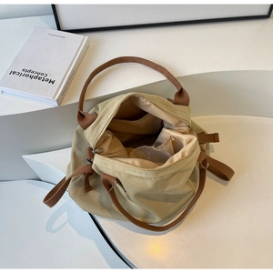 Detail of canvas tote bag with brown straps and spacious interior compartments