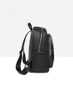 Side view of black pebble grain leather backpack showing side pockets and metal zippers