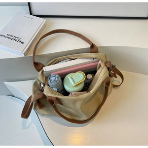 Macro view of khaki canvas tote bag interior showing large storage capacity for daily items