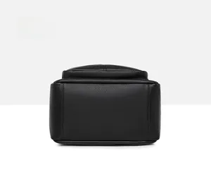 Detailed bottom view of black PU leather backpack showing pebbled texture and reinforced stitching