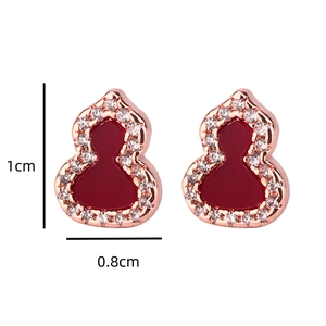 Macro detail of red gourd stud earrings with rose gold pave diamonds and dimensions