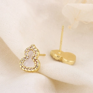 Detail shot of gourd stud earrings with white shell inlay and S925 silver stamp