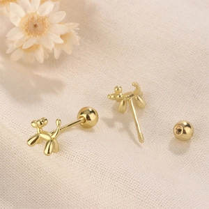Detailed close-up of golden balloon dog stud earrings with secure screw-back design