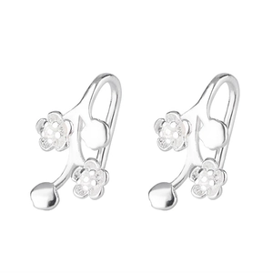 Macro detail of S925 sterling silver plum blossom branch earrings with floral texture