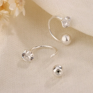 Macro view of C-shaped S925 silver stud earrings with zirconia and screw back