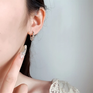 Elegant beaded silver hoop earrings shown on a model for a chic minimalist French style