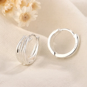 Minimalist multi-layer ribbed S925 silver hoop earrings on textured beige fabric