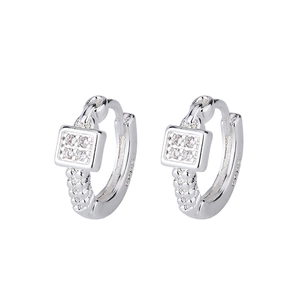 Macro detail of S925 sterling silver stamp and square zircon inlay on silver hoop earrings