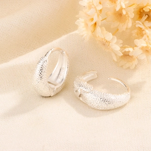Detail of S925 sterling silver hoop earrings with a frosted sandblasted texture finish