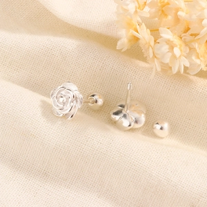 Detailed view of silver rose stud earring with S925 stamp and secure screw back clasp