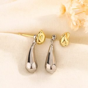 Close-up of two-tone water drop earrings with silver metal and irregular gold texture